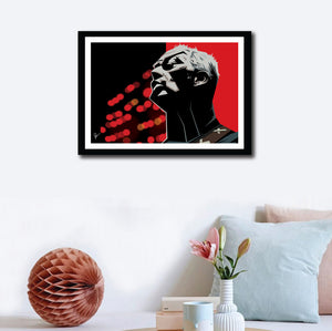 Framed Poster of David Gilmour on a wall decor. Caricature art by Prasad Bhat. Image shows the artist in a performing moment with a angular view of his face. The artwork is predominantly composed with red and black colors.