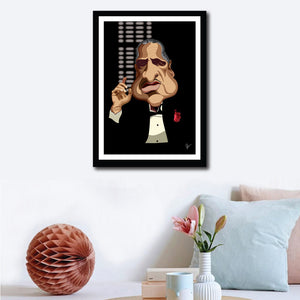 Framed Godfather Poster on a wall decor. Caricature Art by Prasad Bhat showing Don Corleone sitting in his iconic pose with a red pocket rose, his one hand held up and against a black backdrop. 