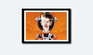Matt Damon in his Caricature Art Form by Prasad Bhat. Image shows framed art poster of Martian avatar by Matt looking straight forward with his sleek eyes . He is wearing the astronaut's suit and helmet against a predominantly orange background.